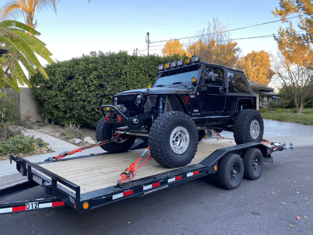 Lifted Jeep loaded on a ROADMOTO flatbed trailer ready for transport in Los Angeles